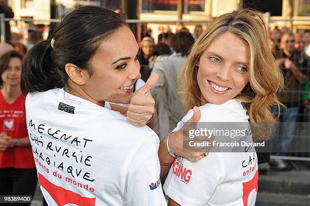 Valerie Begue and Sylvie Tellier pose at the start of the Paris Marathon 2010 on April 11, 2010 in Paris, France.