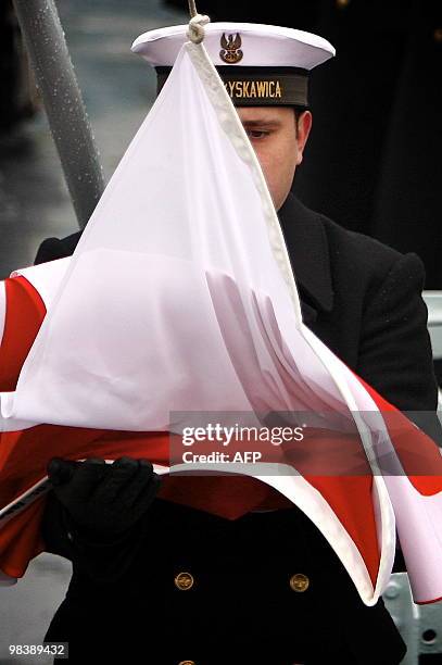 Polish Navy sailor prepares the flag to be flown at half mast in memory of late president Lech Kaczynski , on a ship in dock in Gdynia on April 11,...