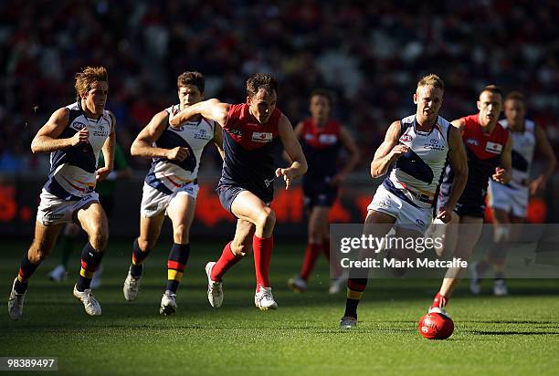 Cameron Bruce of the Demons leads the chase for the ball during the round three AFL match between the Melbourne Demons and the Adelaide Crows at...