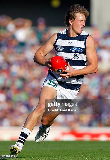 Mitch Duncan of the Cats runs with the ball during the round three AFL match between Fremantle Dockers and the Geelong Cats at Subiaco Oval on April...