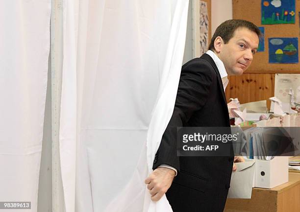 Hungarian Prime Minister Gordon Bajnai leaves the polling both with his ballot in a local polling station of a Budapest elementary school on April...