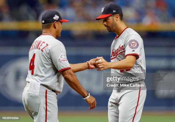 Gio Gonzalez of the Washington Nationals, right, is removed from the game by manager manager Dave Martinez in the second inning of a baseball game...