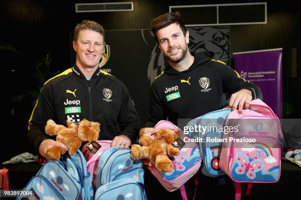 Coach Damien Hardwick and captain Trent Cotchin pose for photos as they pack the Alannah & Madeline Foundations 85,000th Buddy Bag during a Richmond...