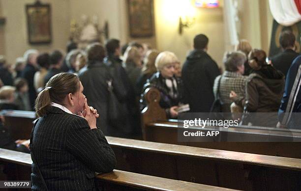 People take part in a church service for Polish president Lech Kaczynski in Berlin on April 11, 2010 the day after a plane carrying Polish president...