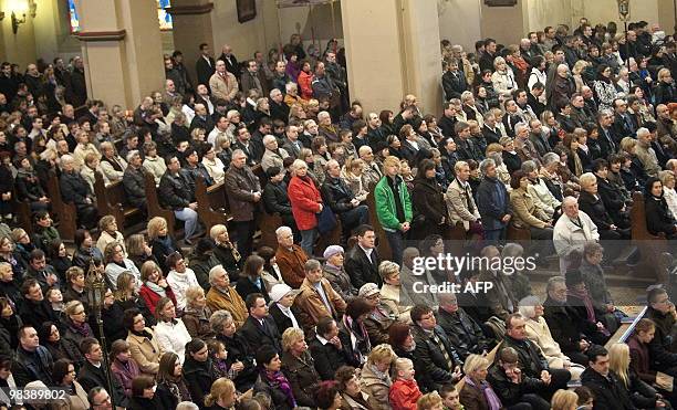 People take part in a church service for Polish president Lech Kaczynski in Berlin on April 11, 2010 the day after a plane carrying Polish president...