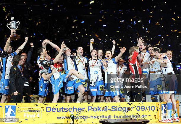 The team of Hamburg is celebrating after winning the DHB Cup Final match between Rhein-Neckar Loewen and HSV Hamburg at the Color Line Arena on April...