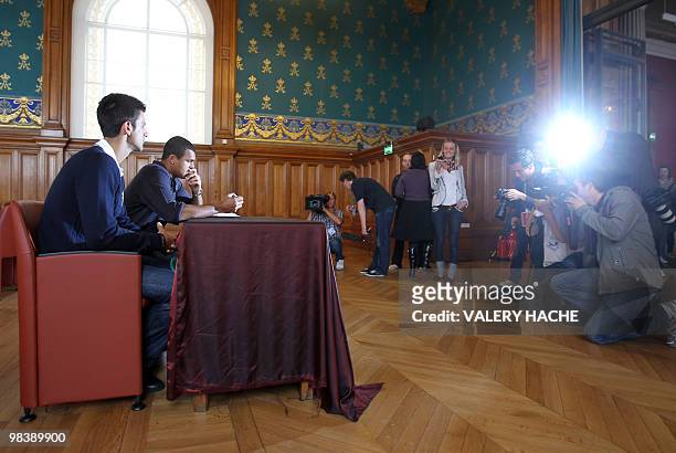 French Jo Wilfried Tsonga and serbian Novak Djokovic sign the guest book after a visit at the Oceanographic Museum in Monaco, on April 11 on the eve...