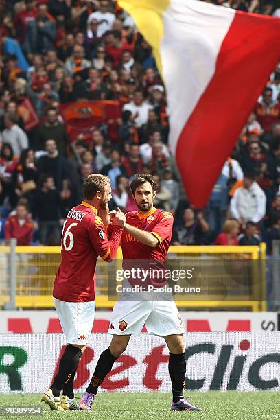 Mirko Vucinic of AS Roma celebrates with team mate Daniele De Rossi after scoring the opening goal during the Serie A match between AS Roma and...