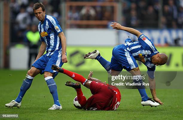 Ze Roberto of Hamburg falls as Joel Epalle jumps over and his team mate Christoph Dabrowski of Bochum looks on during the Bundesliga match between...