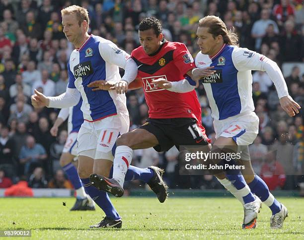 Nani of Manchester United challenges with Michael Salgado and Vince Grella of Blackburn Rovers during the FA Barclays Premier League match between...