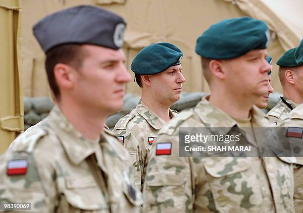 Afghanistan-based Polish soldiers with the NATO-led International Security Assistance Force stand at attention during a memorial ceremony for Polish...