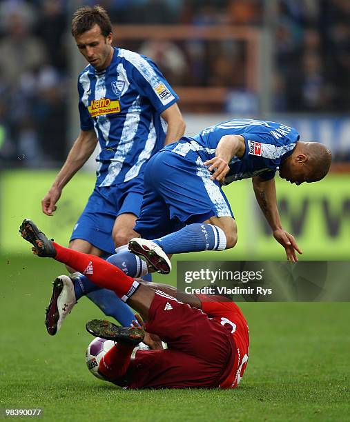 Ze Roberto of Hamburg falls as Joel Epalle jumps over and his team mate Christoph Dabrowski of Bochum looks on during the Bundesliga match between...