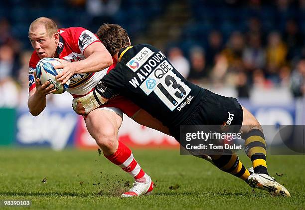 Dom Waldouck of London Wasps tackles running with the ball Mike Tindall of Gloucester during the Amlin Challenge Cup Quarter Final match between...