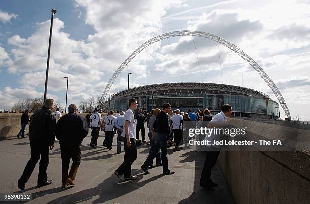 Fans walk towards Wembley Stadium during the FA Cup sponsored by E.ON Semi Final match between Tottenham Hotspur and Portsmouth on April 11, 2010 in...