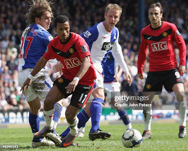 Nani of Manchester United clashes with Michael Salgado and Vince Grella of Blackburn Rovers during the Barclays Premier League match between...