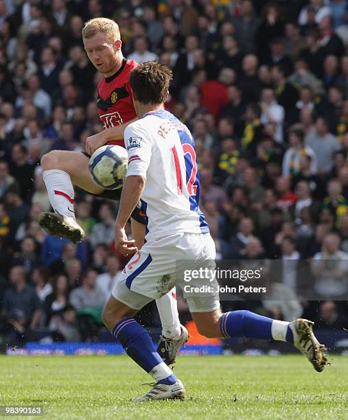 Paul Scholes of Manchester United is challenged by Morten Gamst Pedersen of Blackburn Rovers during the FA Barclays Premier League match between...