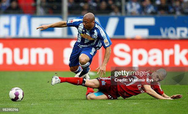 Mladen Petric of Hamburg slides in to Joel Epalle of Bochum during the Bundesliga match between VfL Bochum and Hamburger SV at Rewirpower Stadium on...