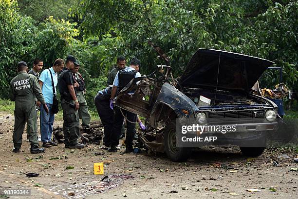 Thai bomb squad members inspect the site of car bomb attack planted by suspected separatist insurgents in the Cha-nea district in Thailand's restive...