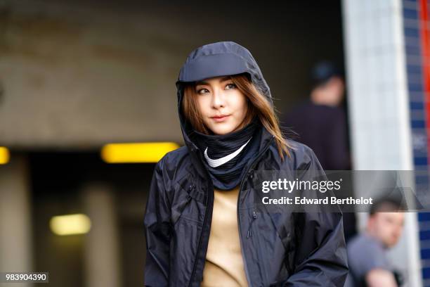 Sandara Park "Dara", Korean singer, wears a black raincoat, a black scarf from Nike, outside 1017 ALYX 9SM, during Paris Fashion Week - Menswear...