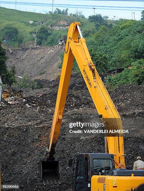 Workers with heavy machinery dig in the mud left by a landslide at Vicoso Jardim Bumba shantytown in Niteroi, 25 km from Rio de Janiero, Brazil on...