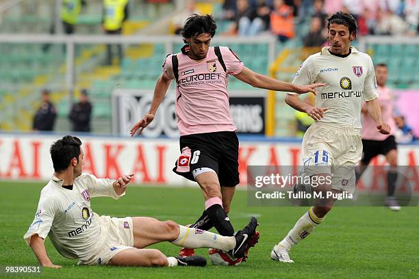 Javier Pastore of Palermo and Andrea Mantovani and Manuel Iori of Chievo compete for the ball during the Serie A match between US Citta di Palermo...