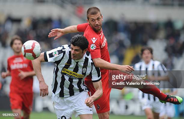 Vincenzo Iaquinta of Juventus FC battles for the ball with Michele Canini of Cagliari Calcio during the Serie A match between Juventus FC and...