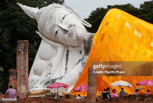 Thais pray at a reclining Buddha during their visits at Wat Khun-Intha Pramul in Ang Thong province, north of Bangkok.