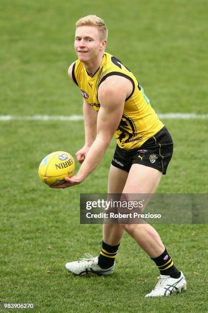 Nathan Drummond handballs during a Richmond Tigers AFL media opportunity at Punt Road Oval on June 26, 2018 in Melbourne, Australia.
