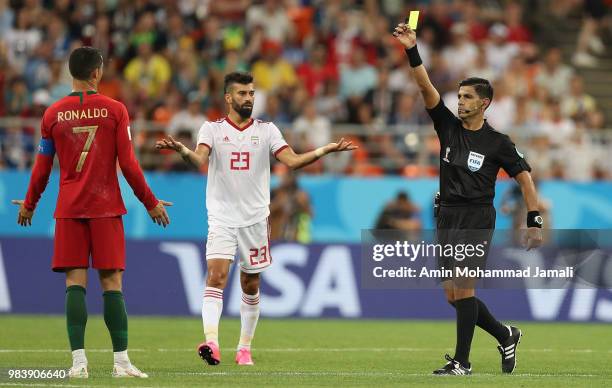 Referee Enrique Caceres shows a yellow card to Cristiano Ronaldo of Portugal during the 2018 FIFA World Cup Russia group B match between Iran and...