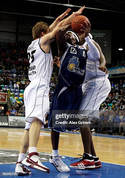 Aubrey Reese of Frankfurt is challenged by Anton Gavel and Elton Brown of Brose Baskets during the final between Deutsche Bank Skyliners Frankfurt...