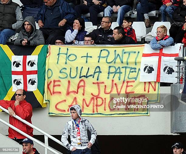 Cagliari supporters shows a banner reading " I have more points on my driver license than Juventus in the championship" during the Serie A football...