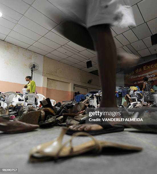 Volunteers organize clothes donated from all over Brazil to be given to victims a landslide in Vicoso Jardim Bumba shantytown in Niteroi, 25 km from...