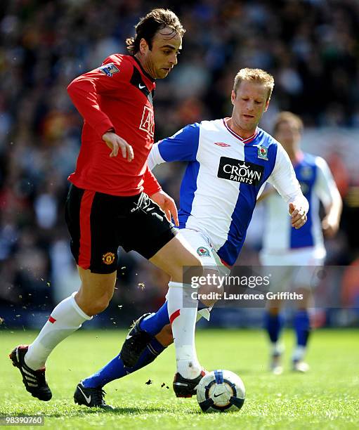 Dimitar Berbatov of Manchester United battles with Vince Grella of Blackburn Rovers during the Barclays Premier League Match between Blackburn Rovers...