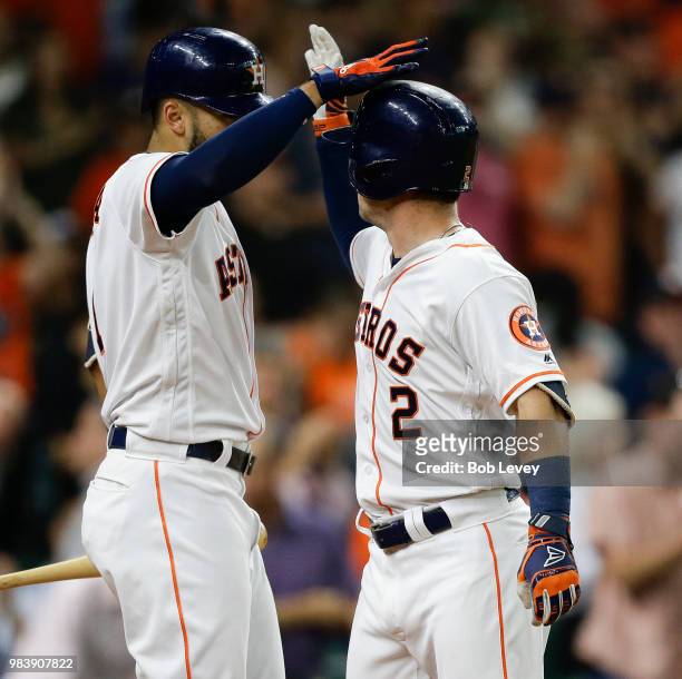 Alex Bregman of the Houston Astros receives congratulations from Carlos Correa after hitting a home run in the third inning against the Toronto Blue...