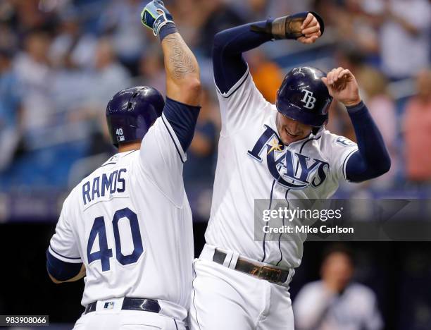 Wilson Ramos of the Tampa Bay Rays celebrates his home run with Daniel Robertson in the sixth inning of a baseball game against the Washington...