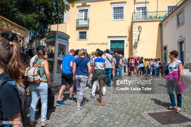 Line of tourists wait to buy tickets to São Jorge Castle, a Moorish fortress in Lisbon, Portugal.
