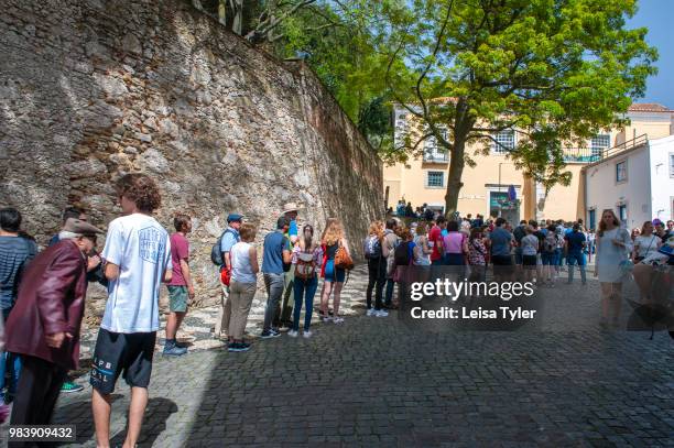 Line of tourists wait to buy tickets to São Jorge Castle, a Moorish fortress in Lisbon, Portugal.