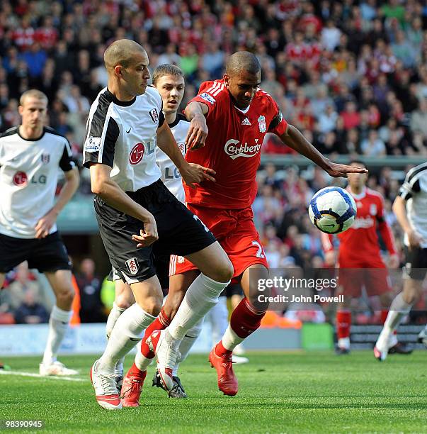 David Ngog of Liverpool competes with Bobby Zamora of Fulham during the Barclays Pemier League match between Liverpool Fulham at Anfield on April 11,...