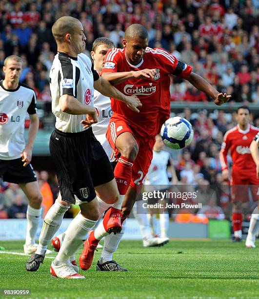 David Ngog of Liverpool competes with Bobby Zamora of Fulham during the Barclays Pemier League match between Liverpool Fulham at Anfield on April 11,...