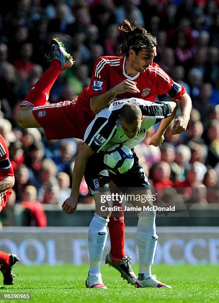 Sotiros Kyrgiakos of Liverpool tangles with Bobby Zamora of Fulham during the Barclays Premier League match between Liverpool and Fulham at Anfield...