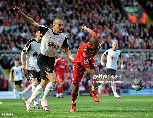 David Ngog of Liverpool competes with Bobby Zamora of Fulham during the Barclays Pemier League match between Liverpool Fulham at Anfield on April 11,...