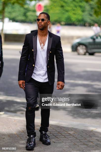 Victor Cruz wears a black blazer jacket, a white top, outside Balmain, during Paris Fashion Week - Menswear Spring-Summer 2019, on June 24, 2018 in...