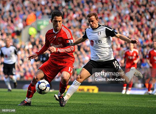 Maxi Rodriguez of Liverpool competes with Erik Nevland of Fulham during the Barclays Pemier League match between Liverpool Fulham at Anfield on April...