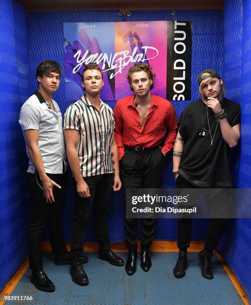 Calum Hood, Ashton Irwin, Luke Hemmings, and Michael Clifford of 5 Seconds of Summer pose backstage before performing at the Tumblr IRL with 5...