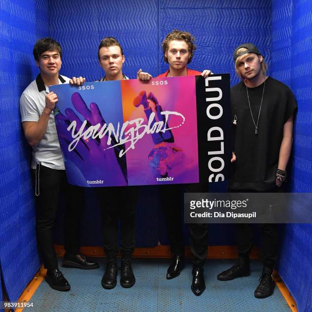 Calum Hood, Ashton Irwin, Luke Hemmings, and Michael Clifford of 5 Seconds of Summer pose backstage before performing at the Tumblr IRL with 5...
