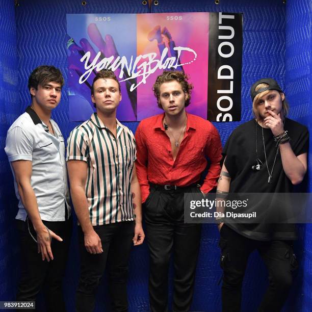 Calum Hood, Ashton Irwin, Luke Hemmings, and Michael Clifford of 5 Seconds of Summer pose backstage before performing at the Tumblr IRL with 5...