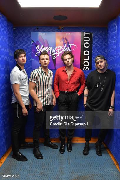 Calum Hood, Ashton Irwin, Luke Hemmings, and Michael Clifford of 5 Seconds of Summer pose backstage before performing at the Tumblr IRL with 5...