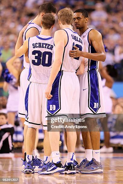 Lance Thomas of the Duke Blue Devils looks on as he huddles up with teammates including Jon Scheyer and Kyle Singler against the Butler Bulldogs...