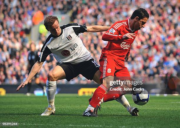 Maxi Rodriguez of Liverpool competes with Erik Nevland of Fulham during the Barclays Pemier League match between Liverpool Fulham at Anfield on April...