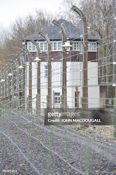 View of a barbed wire fence and a watch tower at the Buchenwald Nazi concentration camp during celebrations marking the 65th anniversary of the...